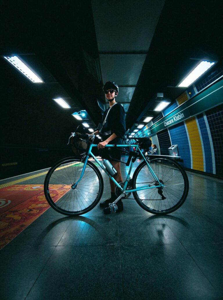 A cyclist in a subway station with a colorful backdrop, depicting urban commuting lifestyle.